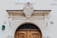 Kaboompics - Ornate Crest and Arched Wooden Door in Krakow