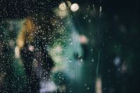 Kaboompics - Rainy Window Pane with Water Droplets and Blurred Garden Lights