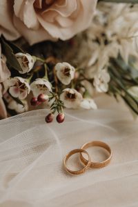 Kaboompics - Wedding Rings Beneath a White Rose and Textured Veil