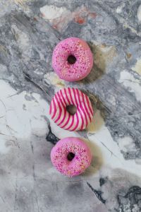 Kaboompics - Three Pink And Striped Donuts On Marble