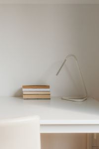 Kaboompics - Minimalist Desk with Books and an Arched Table Lamp