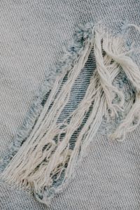 Kaboompics - Frayed Blue Denim Seam With Loose Threads