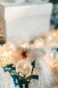Kaboompics - Blurred White Gift Box with Christmas Lights and Baubles