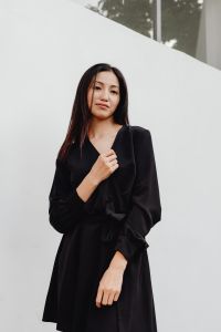 Kaboompics - Close-Up Asian Fashion Portrait of Woman in Black Dress against White Wall