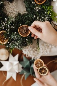 Kaboompics - Hand Adding Dried Orange Slices to Wreath