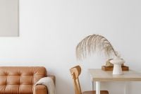 Kaboompics - Neutral Living Room Workspace with Leather Sofa, Wood Desk and Pampas Decor