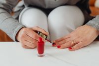 Kaboompics - Relaxed At-Home Manicure with Red Nail Polish in a Cozy Seated Beauty Routine