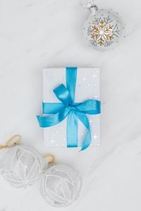 Kaboompics - Snowflake Gift Box with Blue Ribbon and White Bauble, Overhead Holiday Flat Lay