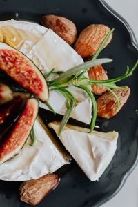 Kaboompics - Camembert Wedge with Fig and Rosemary against White Copy Space
