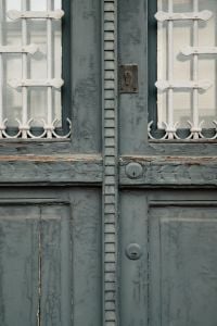 Kaboompics - Vintage Grey Green Double Door with Ornate Iron Grille Detail, Italy