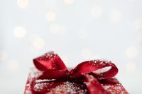 Kaboompics - Red Christmas Present with Sparkling Ribbon and Soft Holiday Bokeh