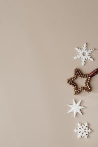 Kaboompics - Beige Holiday Background with White Snowflake and Gold Star Ornament