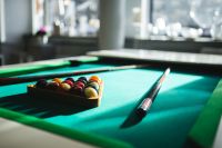 Kaboompics - Billiard balls on green table with billiard cue
