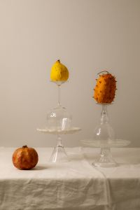 Kaboompics - Lemon and Spiky Fruit on Glass Cake Stands, Neutral Still Life