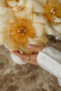 Kaboompics - Close-Up White Peonies with Hands and White Shirt