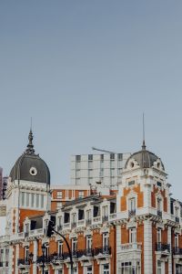 Kaboompics - Twin Rooftop Domes Above Historic Brick and White Stone Facades in Madrid
