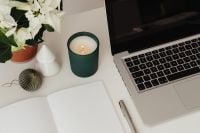 Kaboompics - Green Candle and Laptop With White Christmas Flowers