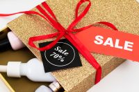 Kaboompics - Close-Up Sale Tags on Gold Gift Box with Beauty Products