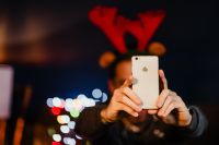 Kaboompics - Man Photographing Christmas Presents with Smartphone
