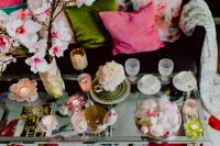 Kaboompics - Wide Easter Coffee Table Setting with Spring Flowers, Tea Cups, Candles and Pastel Eggs