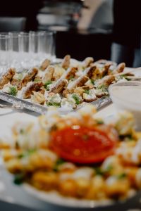 Kaboompics - Close-Up Buffet Canapes with Rows of Glasses and a Bowl of Red Dip