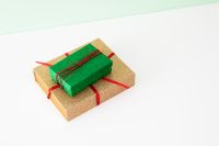 Kaboompics - Wrapped Green Gift on Gold Presents with Copy Space