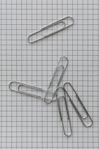 Kaboompics - Silver Paper Clips on Graph Paper Minimal Stationery Background