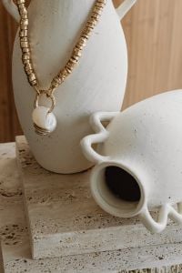 Kaboompics - Gold Necklace on a Ceramic Vase with Coffee Cup