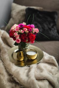 Kaboompics - Romantic Rose Bouquet Framed by Dark Sofa and Soft Textures