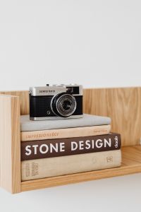 Kaboompics - Olympus Trip 35 Styled with Art Books on a Wooden Display Shelf