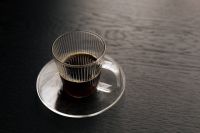 Kaboompics - Overhead Black Coffee in Glass Cup on Black Table