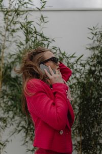 Kaboompics - Woman Talking on a Smartphone in a Fuchsia Blazer