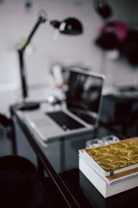 Organized desk with laptop and journals
