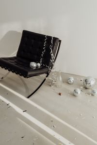 Kaboompics - New Year's Eve Still Life with Disco Balls, Glass Bottle and Cork by Black Chair