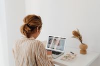 Kaboompics - Woman Working on Laptop at White Desk in Minimal Home Office