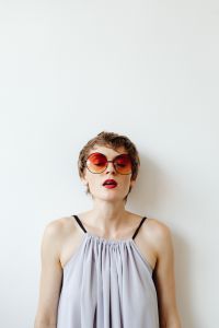 Kaboompics - Woman in Red Sunglasses Posing Against a Clean White Background