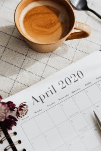 Kaboompics - Coffee Cup and Spoon beside April 2020 Calendar with Astrantia Detail