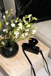 Kaboompics - Flowers And Camera On Stone Table Cozy Home Styling