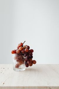 Red Grape Still Life Photography with Crystal Glassware, Hydrangeas and Neutral Table Styling