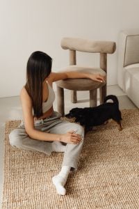 Kaboompics - Woman Resting Her Arm on a Beige Accent Chair in a Minimal Living Room
