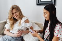 Kaboompics - Teenage Girls Using Smartphones on a Bright Sofa in a Candid Home Lifestyle Scene