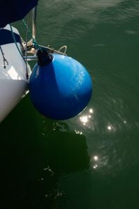 Kaboompics - Blue Boat Fender Floating Above Calm Marina Water