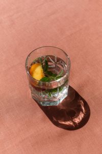Kaboompics - Peach Water With Mint and Coral Copy Space