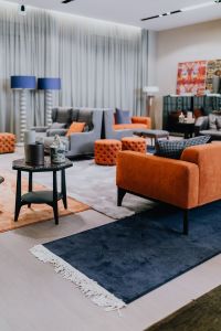Kaboompics - Modern Showroom Lounge with Armchairs, Orange Poufs and Contemporary Furniture