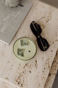Kaboompics - Travertine Table with Green Drink, Black Sunglasses and Art Book
