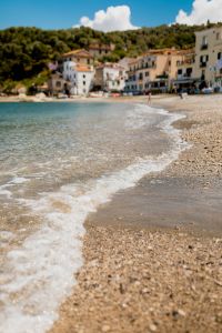 Kaboompics - Soft-Focus Marina di Puolo Village Across a Pebble Beach and Clear Water