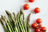 Kaboompics - Fresh Asparagus and Vine Tomatoes on White with Copy Space, Spring Food Background