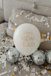 Kaboompics - Happy New Year Balloon and Disco Balls on a Confetti-Covered Sofa
