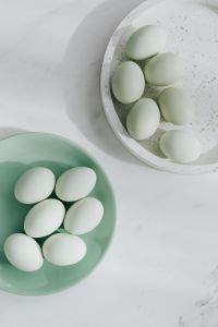 Kaboompics - Easter flat lay with green eggs on a white marble