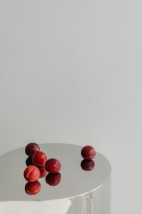Kaboompics - Red Plums on Reflective Chrome Table